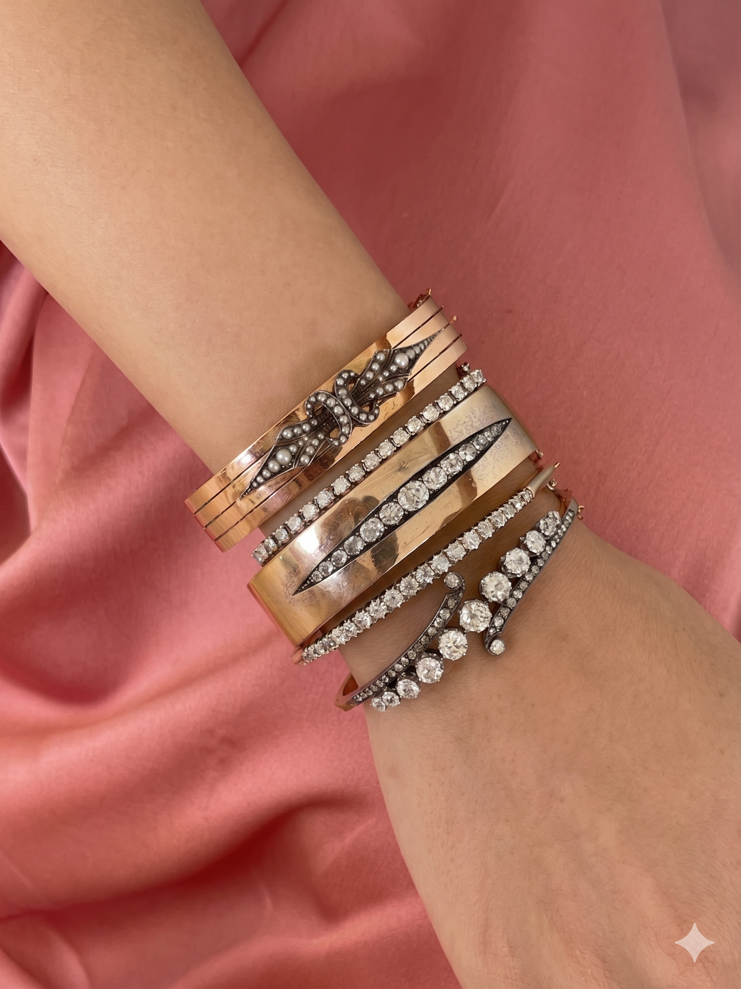 A stack of diamond and gold vintage and antique Victorian cuffs, bangles and bracelets with old mine cut gems